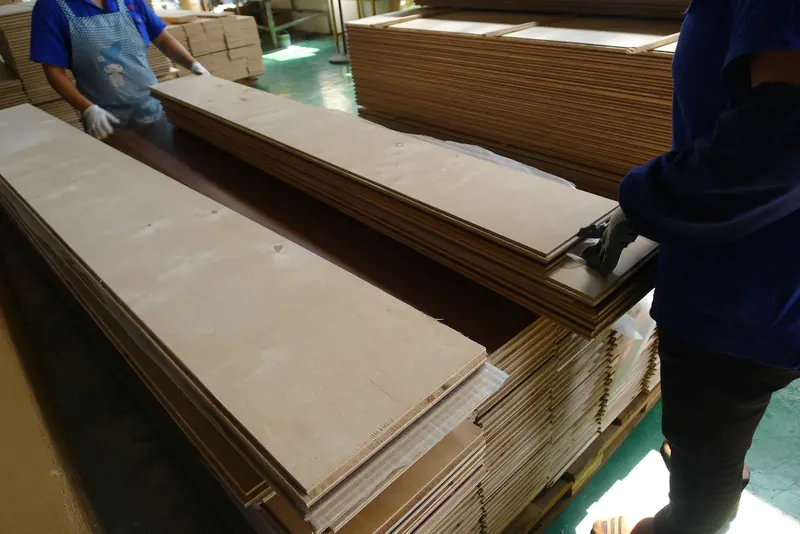 Workers packaging flooring boards